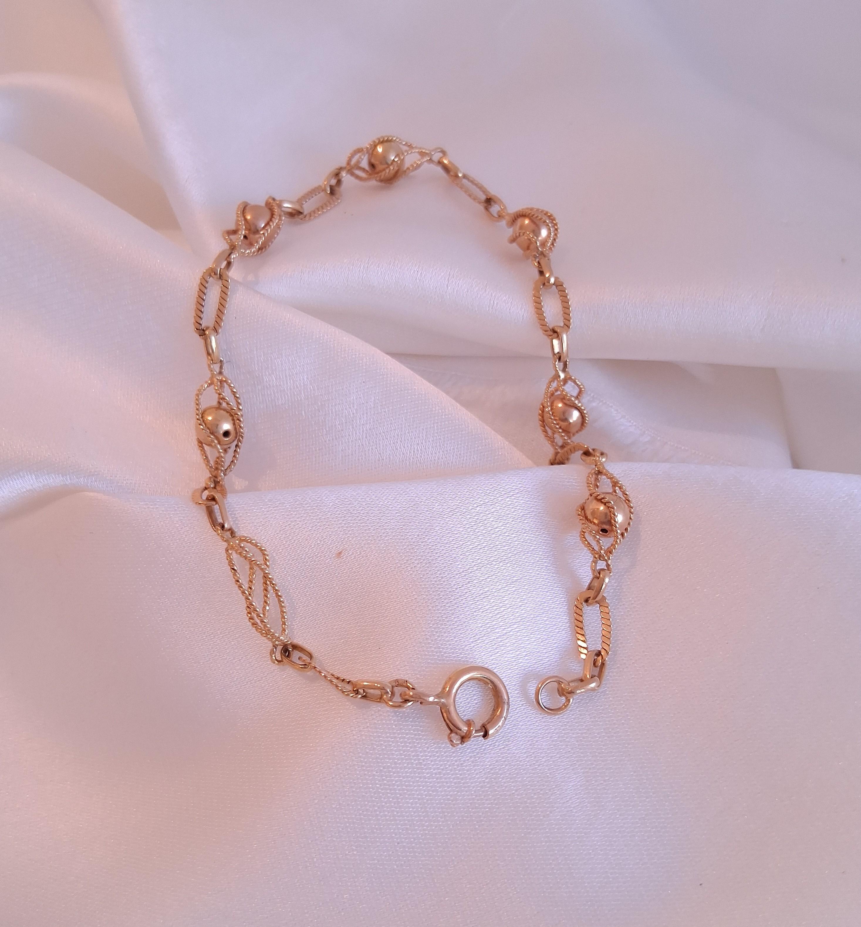 pulseira em elos com bolas no interior , em ouro